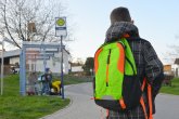 Schüler mit Schulrucksack der Grundschule auf dem morgendlichen Weg zum Schulbus
