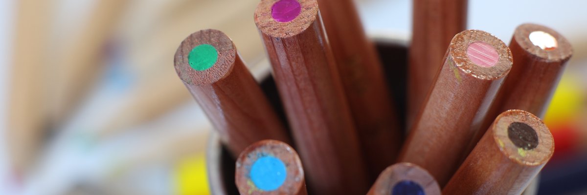 Bunte Stifte in einem Becher.