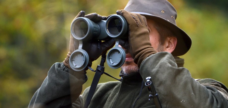 hunter looking through binoculars hunter looking through binoculars